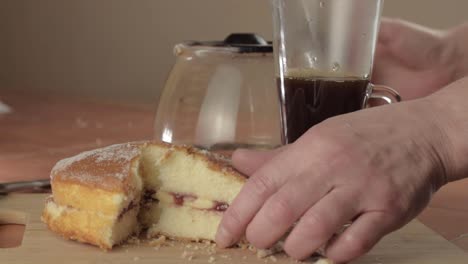 Coffee-and-slice-of-Victoria-sponge-cake-with-hot-drink-wide-shot