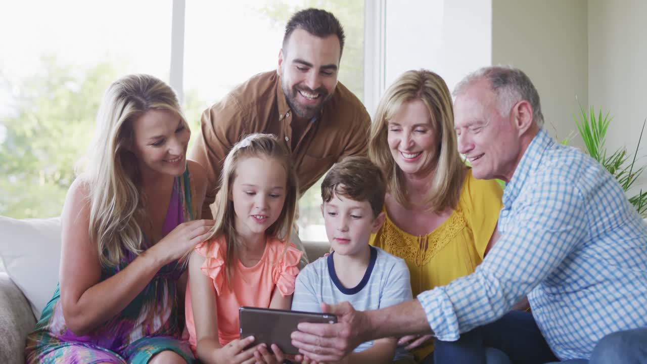 Portrait of six members of a multi-generation Caucasian family spending time at home together