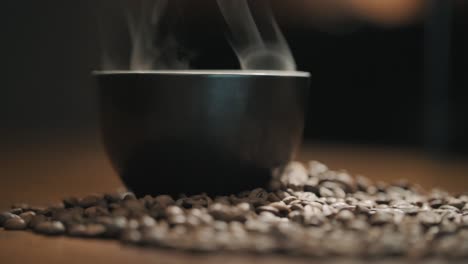 steam over a cup of fresh coffee on a wooden table slow motion