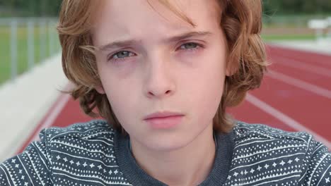 closeup of boy with curly hair, sigh