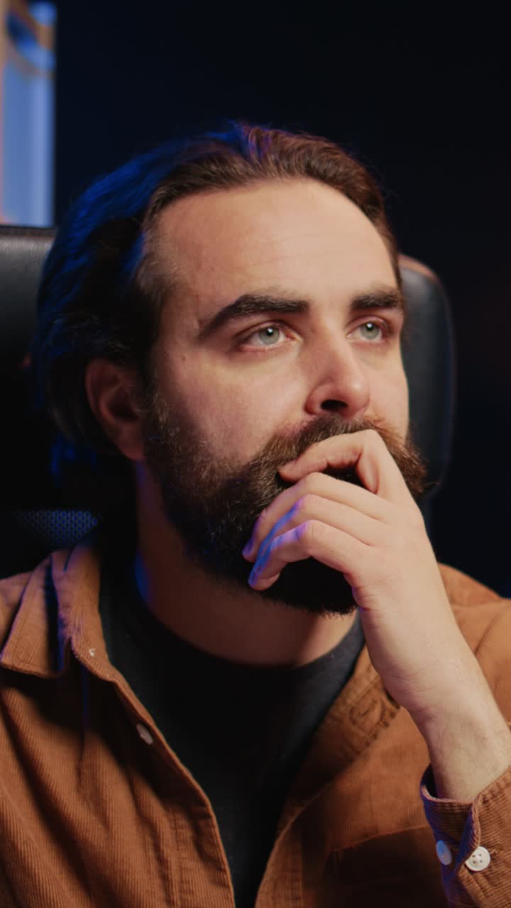 Thoughtful Bearded Man Looking Up and Drinking Coffee