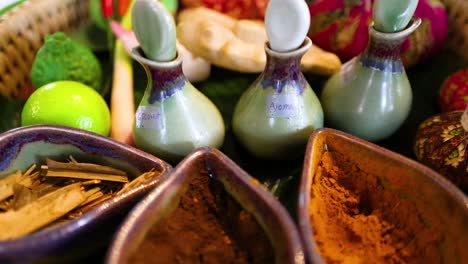 a vibrant display of herbal ingredients and oils used in a traditional thai massage, captured in a serene setting