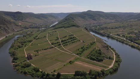 ascending backwards aerial shot of the stunning bremm moselle loop, germany