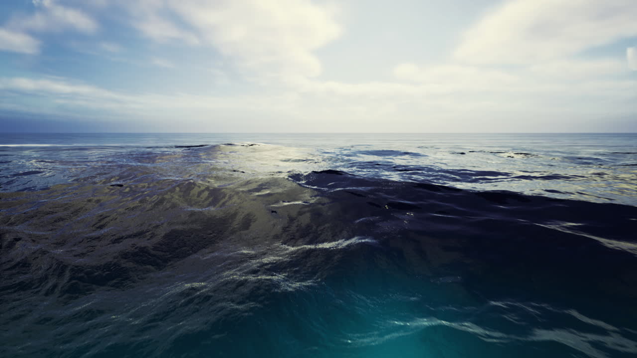 Vast ocean view under a bright sky with gentle waves at midday