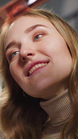 happy couple of white lady with african-american friend looks at processed coloured film roll with family pictures in studio closeup slow motion