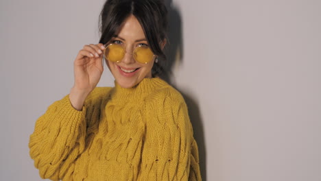 woman in yellow sweater and sunglasses