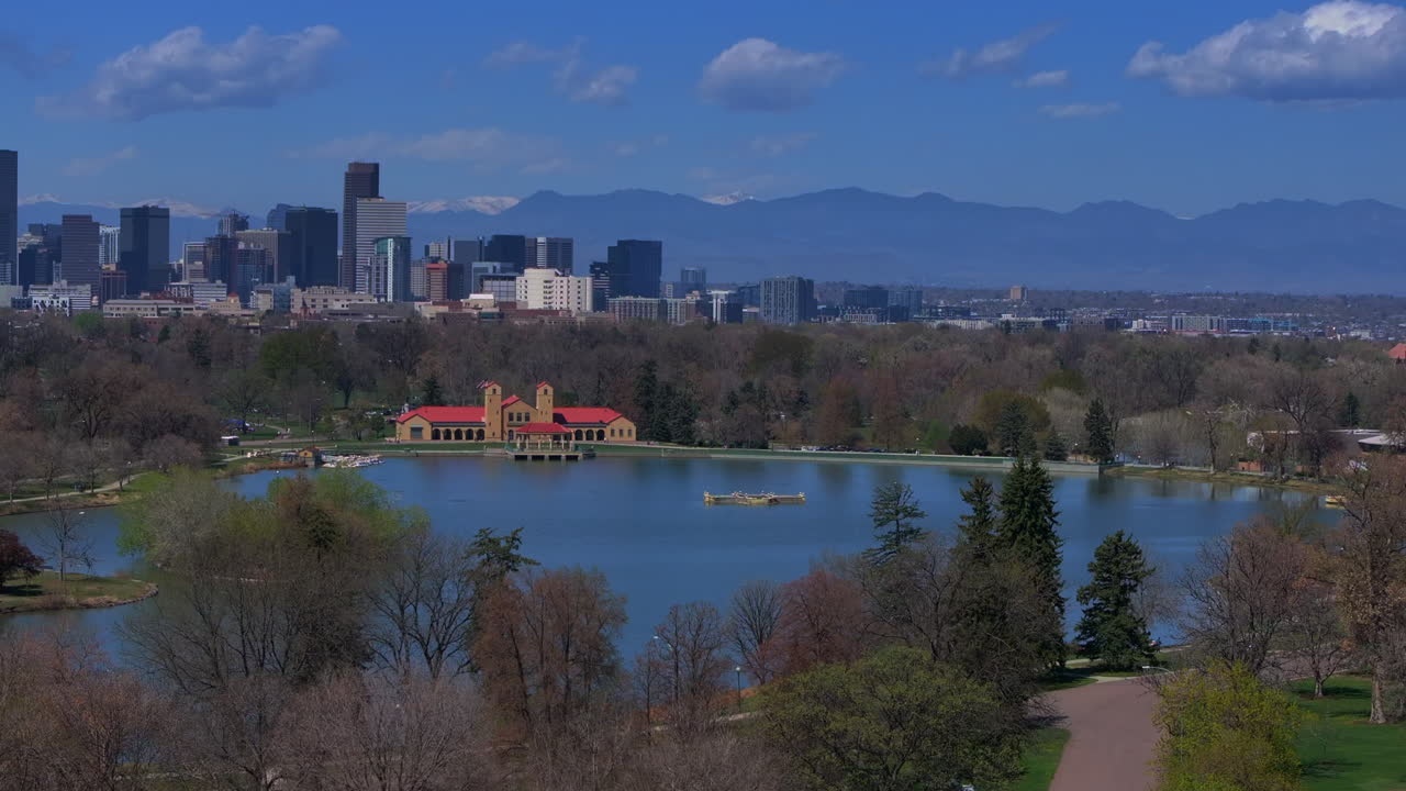 Downtown Denver City Park Colorado aerial drone Pavillon springtime summer tree wildflower blossom sunny morning blue sky Ferril Duck Lake bike walking path tall buildings skyscrapers pan left