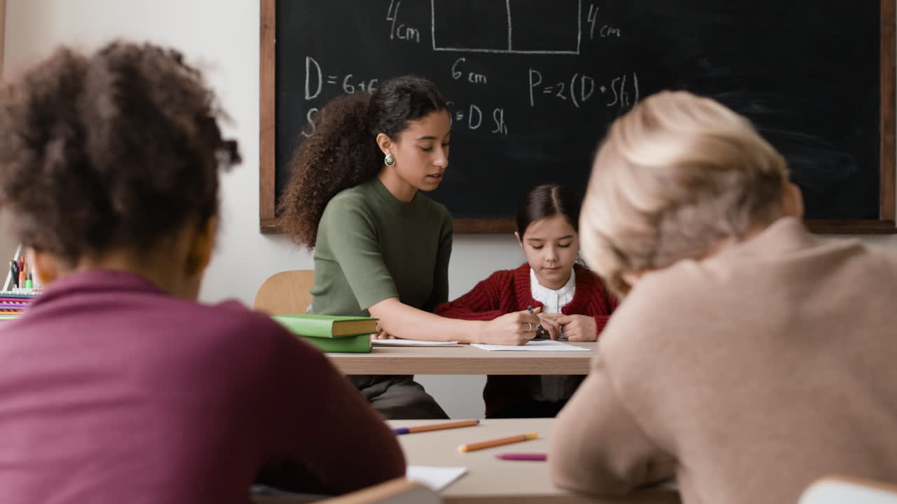Classroom Scene: Teacher Assisting Students
