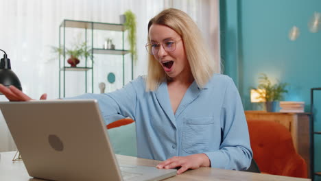 surprised amazed woman girl with windswept hair opening using laptop receive mail good news message