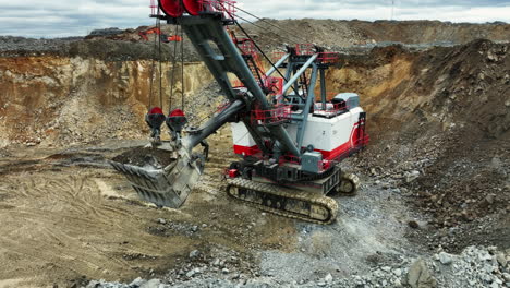 large excavator operating in an open-pit mine