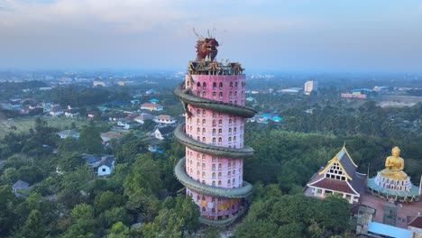 the wat samphran temple with huge dragon coiled around and protecting it in thailand