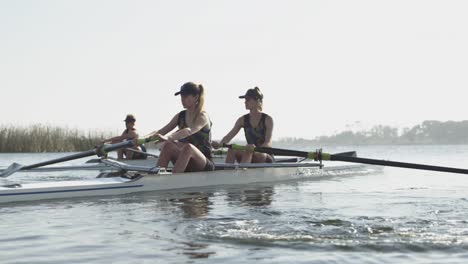 female rowing team training on a river