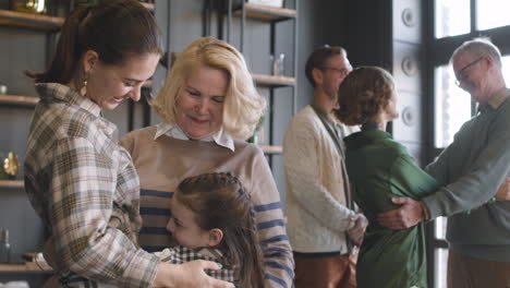 happy family visiting grandparents at home and embracing together 3