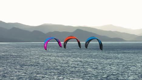 kiteboarding en el mar con montañas de fondo