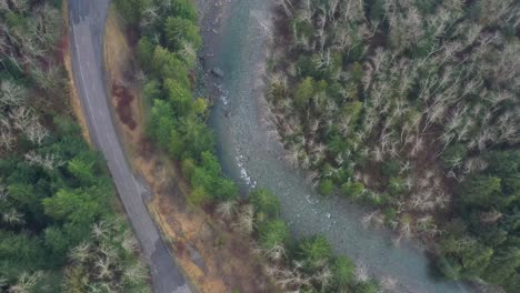 overhead aerial view over a river and highway in the cascade mountains