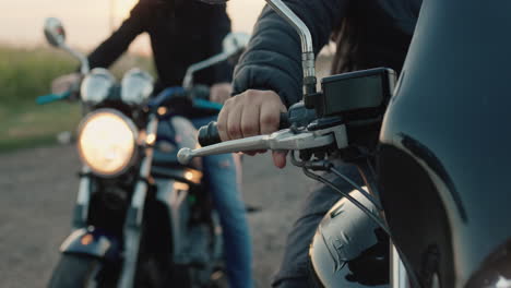 Three-motorcyclists-start-their-motorcycles