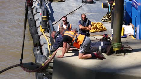 man in life jacket working on dock