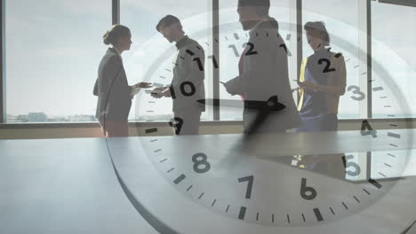 animation of clock with fast moving hands over diverse business colleagues talking