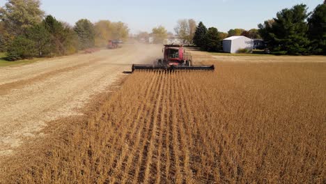 combine harvesting soybeans with rotating header in monroe county michigan, usa