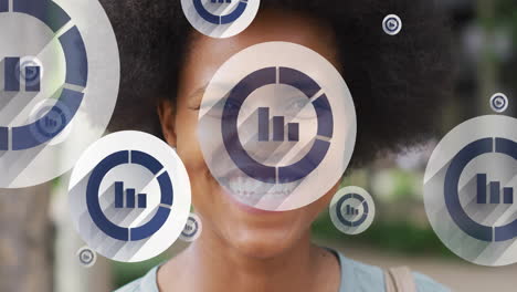 animation of statistics icons over smiling african american woman in city