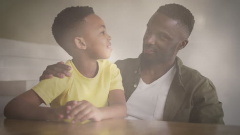 animación de luces sobre feliz padre y hijo afroamericano hablando
