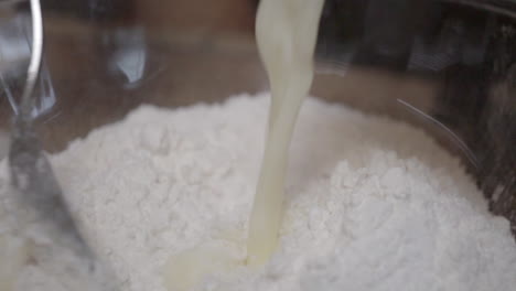 mixing buttermilk into flour to make delicious homemade dough - slow motion