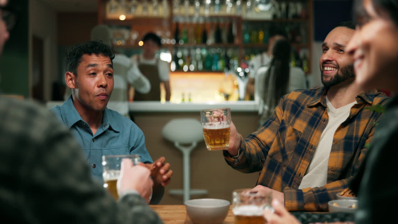 Friends toasting beers at a bar