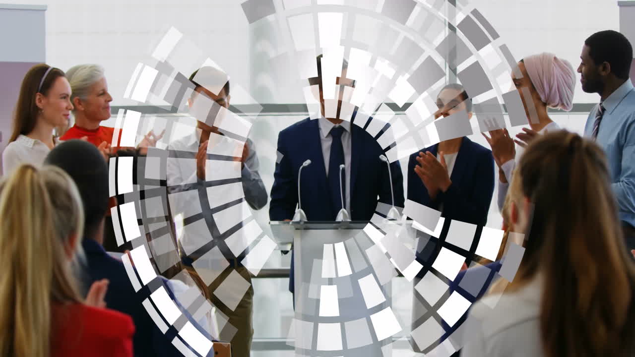 Applauding diverse team in business meeting with geometric animation overlay
