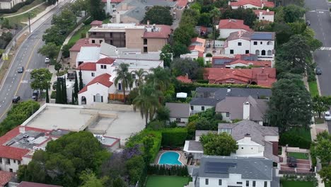 aerial view flying above westwood expensive neighborhood property rooftops, los angeles