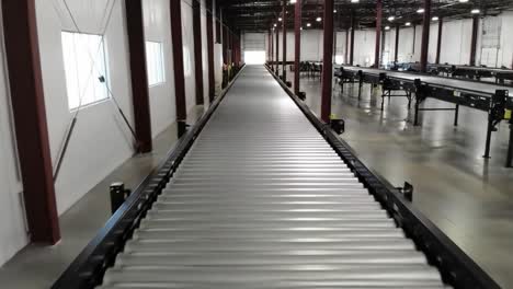 a long conveyor belt inside a spacious industrial facility with clear lines of sight and standardized infrastructure for efficient material movement