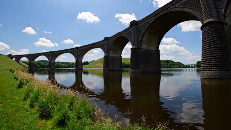 a majestic stone arch bridge over a calm river