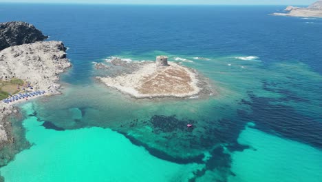 La-Pelosa-island-and-medieval-tower-in-Sardinia,-Italy---4k-Aerial