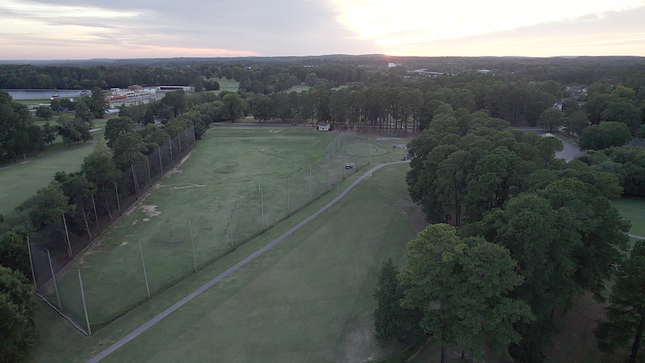 Sunset over golf course, dusk, long driving range, 18-hole course