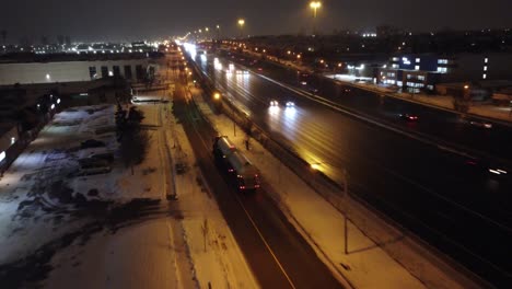 Aerial-dolly-follows-large-gas-tanker-truck-driving-along-highway-at-night