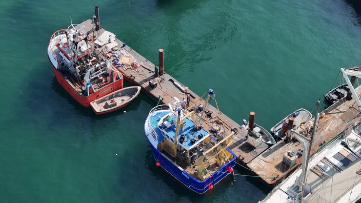 Overhead birds eye drone aerial view fishing boats Polruan Cornwall UK