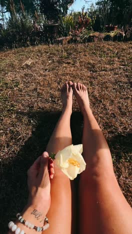 woman relaxing in garden with flower