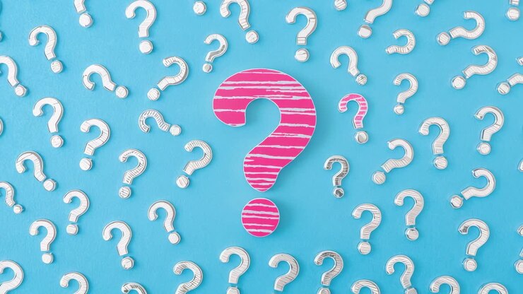 Displaying pink-striped question mark on light blue backdrop, with white question marks