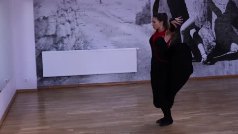 Professional-female-dancer-dances-on-the-dance-floor-in-front-of-the-mirror