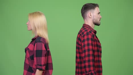 young happy couple smiling after facing each other
