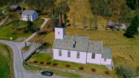 old church building with cemetery in norway, aerial orbit view