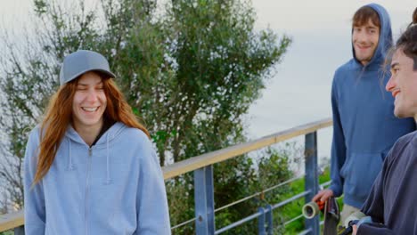 front view of young caucasian skateboarders standing with skateboard at observation point 4k