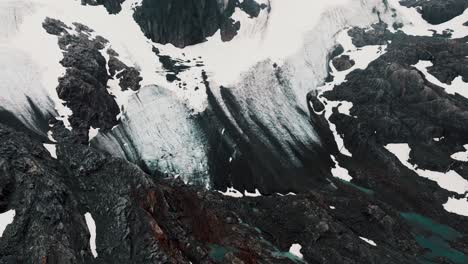 glacier ice and snow in the mountain peak, glaciar vinciguerra in ushuaia, tierra del fuego, patagonia argentina - drone shot