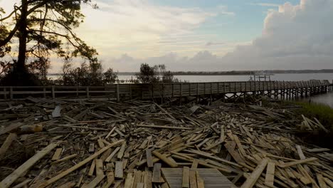 Aerial-footage-of-flooded-and-damaged-docks-on-the-North-Carolina-shoreline-after-Hurricane-Florence-with-a-beautiful-sky-in-the-background