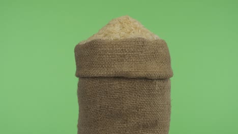 rotating a full bag of rice grain. close-up.