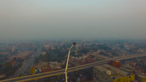 Rescue-volunteers-in-cage-of-fire-rescue-snorkel,-Urban-city-top-view-with-roads-and-bridge,-Huge-traffice-on-the-roads,-Bombay,-India