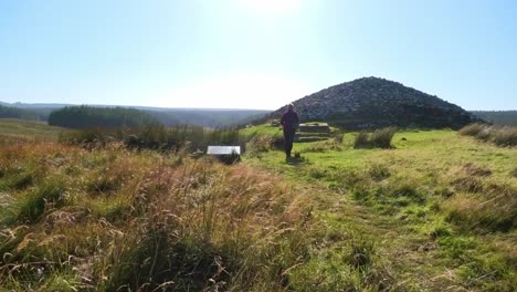 Visitor-to-the-Grey-Camster-Chambered-Cairns-reads-the-notice-board-and-moves-towards-the-long-cairn