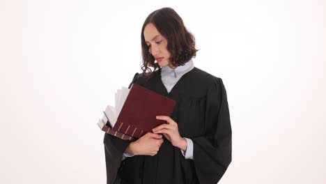 woman in academic robe holding books