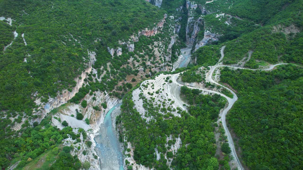 Beautiful canyon river emerald water flows to Benje thermal springs with tourists by stone bridge