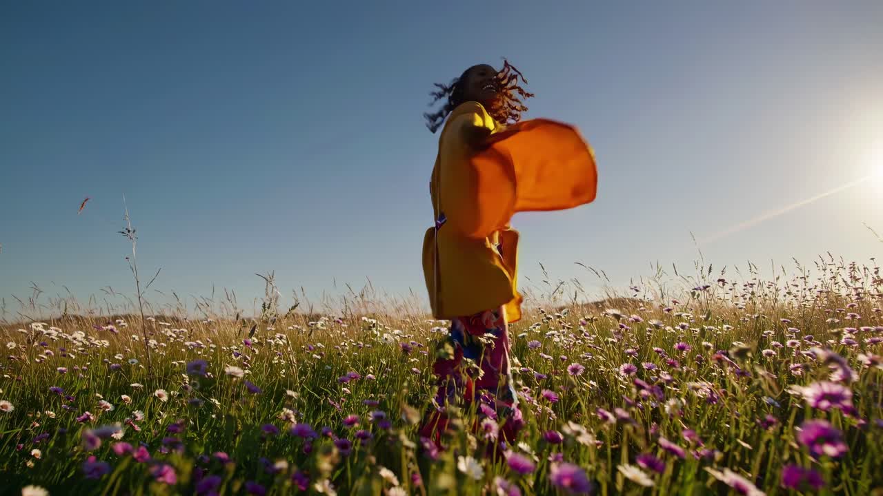 mujer saltando de alegría en un campo de flores