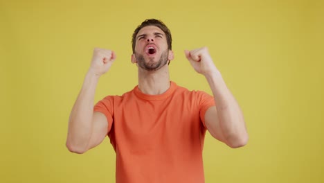 man expressing intense triumph and excitement with shouts and raised fists